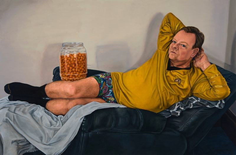 Bro con Queso shows a recumbent man propped up on his left elbow as he lies upon red satin fabric in a dark room. He is wearing a plaid shirt with blue jeans, and he poses with processed cheese flavored snacks. 
